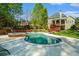 Inviting pool area with lush landscaping, spa, seating, mature trees, and serene backyard setting at 2012 Golfers Way, Villa Rica, GA 30180