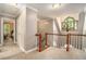 Upstairs hallway features a chandelier, access to bedrooms, and staircase to the lower level at 2012 Golfers Way, Villa Rica, GA 30180