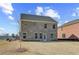 A freshly built brick house is the focal point, featuring a large, grassy backyard under a partly cloudy sky at 612 Leafy Branch Way, Mcdonough, GA 30253