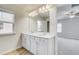 Bathroom with double vanity, modern lighting and mirror at 612 Leafy Branch Way, Mcdonough, GA 30253