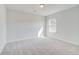 Bright bedroom featuring neutral carpeting and a sunlit window at 612 Leafy Branch Way, Mcdonough, GA 30253