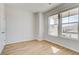 Bright bedroom features wood-look floors, white walls, and plenty of natural light at 612 Leafy Branch Way, Mcdonough, GA 30253