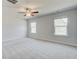 Spacious bedroom with neutral carpet, ceiling fan, and natural light from two windows at 612 Leafy Branch Way, Mcdonough, GA 30253