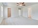 Open bedroom with neutral carpet and views into closet and hallway at 612 Leafy Branch Way, Mcdonough, GA 30253