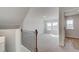 Upstairs bonus room with large windows, plush carpets, and a hall to the bedrooms at 612 Leafy Branch Way, Mcdonough, GA 30253