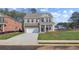Charming two-story brick home featuring a two-car garage and manicured front lawn at 612 Leafy Branch Way, Mcdonough, GA 30253
