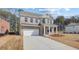 Charming two-story brick home featuring a two-car garage and manicured front lawn at 612 Leafy Branch Way, Mcdonough, GA 30253