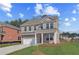 Charming two-story brick home featuring a two-car garage and manicured front lawn at 612 Leafy Branch Way, Mcdonough, GA 30253