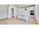 Bright kitchen features wood flooring, stainless steel appliances, white cabinets and a large walk-in pantry at 612 Leafy Branch Way, Mcdonough, GA 30253