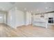 Bright kitchen features wood flooring, stainless steel appliances, white cabinets and a kitchen island at 612 Leafy Branch Way, Mcdonough, GA 30253