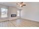 Spacious living room features hardwood floors, neutral walls, and modern fireplace at 612 Leafy Branch Way, Mcdonough, GA 30253