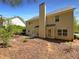 Backyard with mulched beds, a patio and a view of the rear exterior of the home at 956 Buckhorn Bnd, Locust Grove, GA 30248