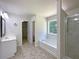 Bathroom featuring a soaking tub, a shower and a single sink vanity at 956 Buckhorn Bnd, Locust Grove, GA 30248