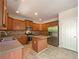 Well-equipped kitchen boasts stainless steel appliances, ample counter space, and warm wood cabinetry at 956 Buckhorn Bnd, Locust Grove, GA 30248