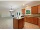 Open-concept kitchen with island, stainless steel appliances, adjacent to living area with natural light and modern finishes at 956 Buckhorn Bnd, Locust Grove, GA 30248