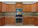 Functional kitchen showcases stainless steel appliances, abundant counter space, and well-maintained wooden cabinets at 956 Buckhorn Bnd, Locust Grove, GA 30248