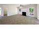 Expansive living room features a cozy fireplace, large windows, and ample space for entertaining and relaxation at 956 Buckhorn Bnd, Locust Grove, GA 30248