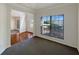 Comfortable living room with a large window and neutral carpet at 956 Buckhorn Bnd, Locust Grove, GA 30248