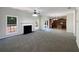Spacious living room featuring a fireplace, large windows, and an open layout connecting to the kitchen area at 956 Buckhorn Bnd, Locust Grove, GA 30248