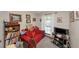 Small bedroom with red sofa, bookshelf and window overlooking the exterior at 3560 Riverchase Dr, Decatur, GA 30034