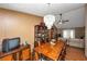 Bright dining room with a chandelier, a large wooden table, seating for eight, and view to the living room at 3560 Riverchase Dr, Decatur, GA 30034