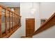 Elegant entryway featuring a wooden staircase and a stylish chandelier, creating a welcoming ambiance at 3560 Riverchase Dr, Decatur, GA 30034