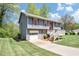 A charming home featuring a garage, a neatly maintained lawn, and an inviting front porch at 3560 Riverchase Dr, Decatur, GA 30034