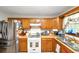 Practical kitchen featuring wood cabinets, laminate countertops, and stainless steel refrigerator at 3560 Riverchase Dr, Decatur, GA 30034