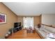 Inviting living room with wood floors, a comfortable couch, and abundant natural light from large windows at 3560 Riverchase Dr, Decatur, GA 30034