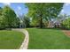 Serene backyard featuring a stone pathway and well-maintained lawn, perfect for outdoor enjoyment at 1102 Emory St, Oxford, GA 30054