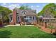Expansive backyard with a patio, lounge seating, and manicured lawn, perfect for outdoor enjoyment at 1102 Emory St, Oxford, GA 30054