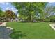 Lush green backyard with a stone path and mature trees creating a private and tranquil setting at 1102 Emory St, Oxford, GA 30054
