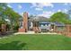 A sprawling backyard featuring a patio, lush lawn, and an inviting outdoor pizza oven at 1102 Emory St, Oxford, GA 30054