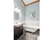 Bathroom with a pedestal sink and clawfoot bathtub with tile floors at 1102 Emory St, Oxford, GA 30054
