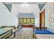 Bedroom with a decorative bay window, built in bench, and colorful rug at 1102 Emory St, Oxford, GA 30054