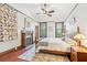 Bedroom with a fireplace, wood floors, decorative quilt, and windows at 1102 Emory St, Oxford, GA 30054