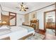 Bedroom with fireplace, wood floors, decorative quilt, and bathroom access at 1102 Emory St, Oxford, GA 30054
