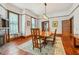 Formal dining room with wood floors, natural light, and an ornate fireplace at 1102 Emory St, Oxford, GA 30054
