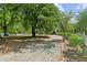 Long driveway lined with brick leading to a charming home surrounded by mature trees at 1102 Emory St, Oxford, GA 30054