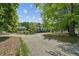 Two-story home with columned front porch and circular driveway surrounded by mature trees at 1102 Emory St, Oxford, GA 30054