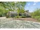 Spacious home featuring a long, circular driveway and solar panels on the detached garage at 1102 Emory St, Oxford, GA 30054