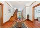 Inviting foyer with hardwood floors, traditional wood trim, staircase, and vintage details at 1102 Emory St, Oxford, GA 30054