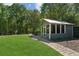 Charming screened-in garden shed nestled in a lush backyard, offering a tranquil retreat at 1102 Emory St, Oxford, GA 30054