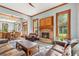 Inviting living room with wood trim, fireplace, and open layout to kitchen and dining areas at 1102 Emory St, Oxford, GA 30054