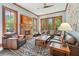 Cozy living room with a brick fireplace, hardwood floors, and abundant natural light at 1102 Emory St, Oxford, GA 30054
