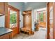 Inviting mudroom featuring custom wood built-ins, tiled floor, and natural light from the exterior door at 1102 Emory St, Oxford, GA 30054