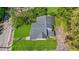 Aerial view of a home with a well-maintained lawn, mature trees, and a classic roof design at 1685 Carroll Nw Dr, Atlanta, GA 30318