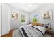 Cozy bedroom with hardwood floors, white walls, and plenty of natural light at 1685 Carroll Nw Dr, Atlanta, GA 30318