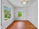 Bedroom with hardwood floors and bright, large windows overlooking the yard at 1685 Carroll Nw Dr, Atlanta, GA 30318