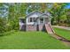 Charming home with a well-maintained lawn and stone foundation at 1685 Carroll Nw Dr, Atlanta, GA 30318
